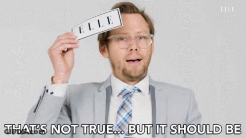 A Man In A Suit And Tie Is Holding A Piece Of Paper With The Word Elle On It GIF