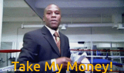 A Man In A Suit And Tie Is Holding A Stack Of Money And Says Take My Money GIF