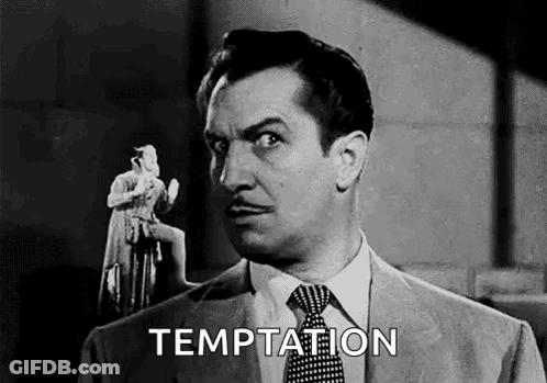 A Man In A Suit And Tie Is Holding A Statue Of A Woman In His Hand . GIF