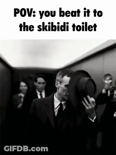 A Man In A Suit And Tie Is Holding A Top Hat In Front Of His Face While Walking Down An Elevator . GIF