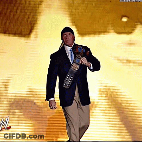 A Man In A Suit And Tie Is Holding A Wrestling Belt That Says ' Intercontinental ' On It GIF