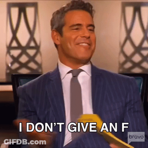 Man In Suit Holding Yellow Object Saying I Don T Give An F GIF