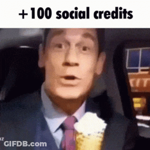 A Man In A Suit And Tie Is Holding An Ice Cream Cone With Whipped Cream On Top . GIF