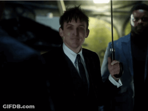 A Man In A Suit And Tie Is Holding An Umbrella And Says All In Fun GIF