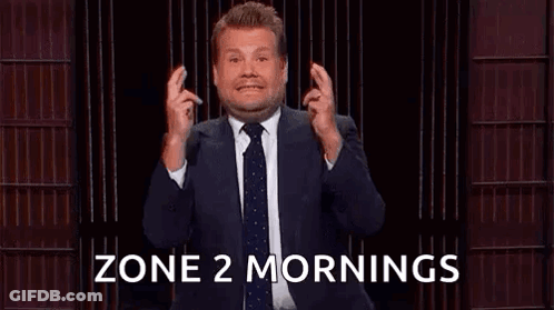 A Man In A Suit And Tie Is Holding His Fingers Crossed In Front Of A Podium . GIF