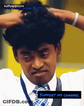 A Man In A Suit And Tie Is Holding His Hair In His Hands GIF