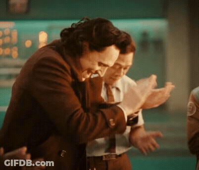 A Man In A Suit And Tie Is Hugging Another Man In A Suit And Tie . GIF