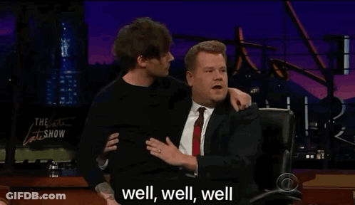 A Man In A Suit And Tie Is Hugging Another Man In A Suit And Tie . GIF