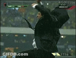 A Man In A Suit And Tie Is Jumping In The Air In Front Of A Screen That Says 4Gifs.com On It GIF