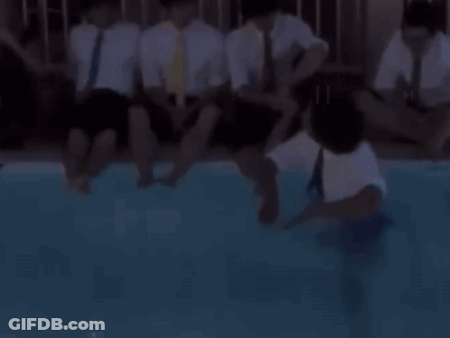 A Man In A Suit And Tie Is Jumping Into A Pool GIF