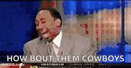 A Man In A Suit And Tie Is Laughing And Says How Bout Them Cowboys . GIF