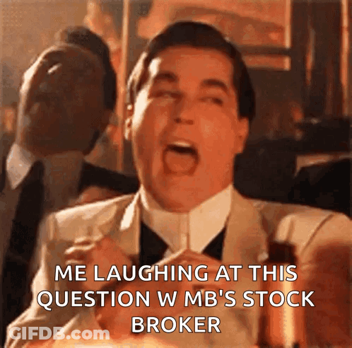A Man In A Suit And Tie Is Laughing At A Question About A Stock Broker GIF