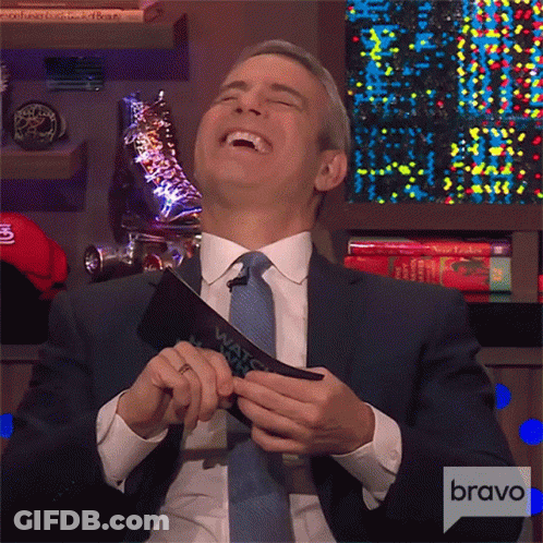 Man In Suit Laughing Holding Bravo Card GIF