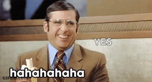 A Man In A Suit And Tie Is Laughing While Holding A Napkin And A Banana . GIF