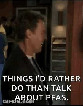 A Man In A Suit And Tie Is Laughing While Talking About Pfas . GIF