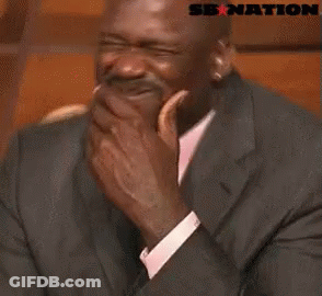 A Man In A Suit And Tie Is Laughing With A Sb Nation Logo Behind Him . GIF