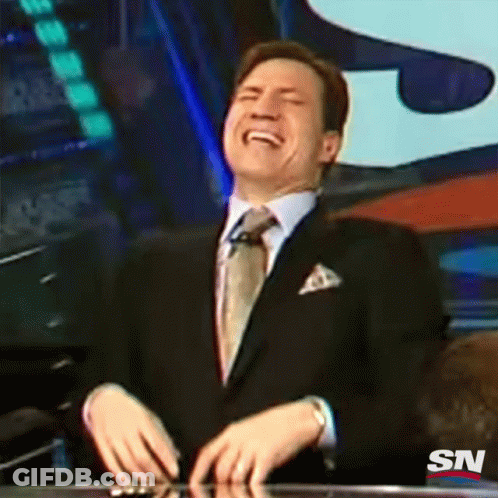 A Man In A Suit And Tie Is Laughing With A Sn Logo In The Background GIF