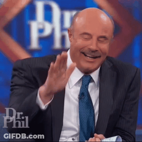 A Man In A Suit And Tie Is Laughing With His Eyes Closed In Front Of A Dr Phil Logo GIF