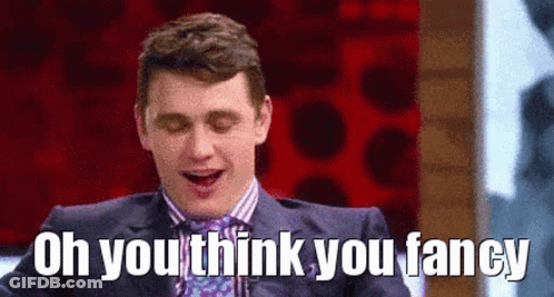 A Man In A Suit And Tie Is Laughing With His Mouth Open And The Words `` Oh You Think You Fancy '' . GIF