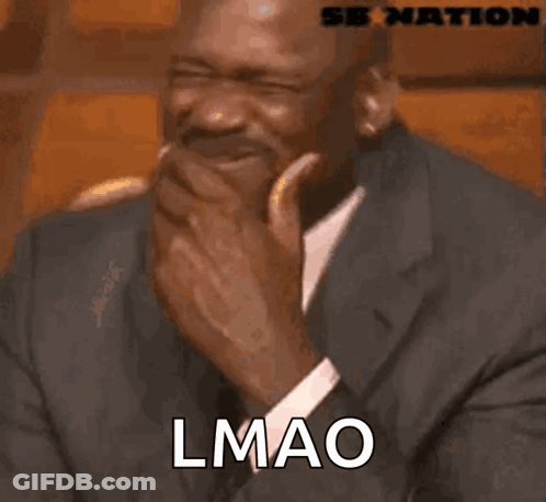 A Man In A Suit And Tie Is Laughing With The Word Lmao Written On His Face GIF