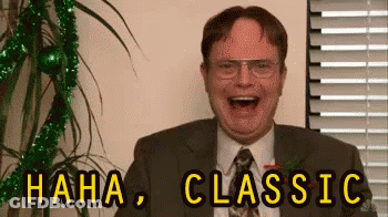 A Man In A Suit And Tie Is Laughing With The Words `` Haha , Classic '' Written Above Him . GIF