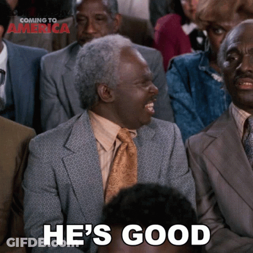 A Man In A Suit And Tie Is Laughing With The Words He 'S Good Below Him GIF