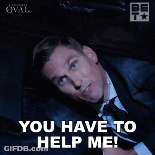 A Man In A Suit And Tie Is Laying Down With The Words You Have To Help Me GIF