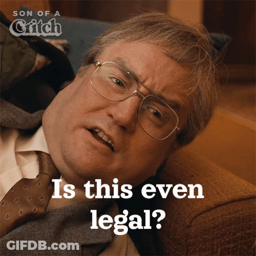 A Man In A Suit And Tie Is Laying On A Couch And The Caption Says " Is This Even Legal " GIF
