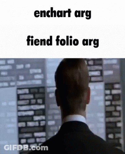 A Man In A Suit And Tie Is Looking At A Computer Screen With The Words Enchart Arg Fiend Folio Arg Written Above Him . GIF
