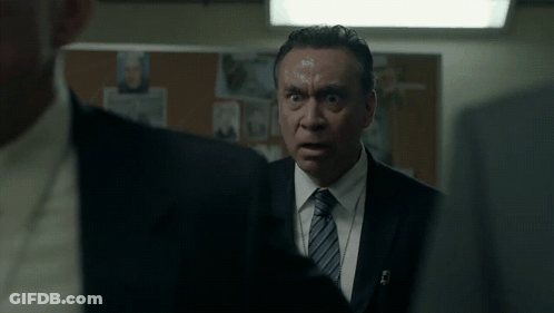 Two Men In Suits Looking At Each Other GIF