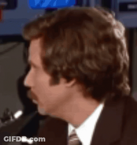 A Man In A Suit And Tie Is Looking At Something GIF