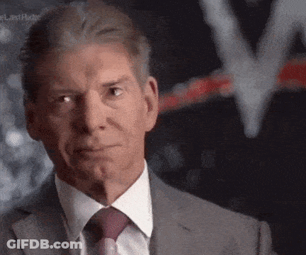A Man In A Suit And Tie Is Looking At The Camera With A Serious Look On His Face . GIF
