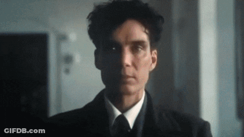 A Man In A Suit And Tie Is Looking At The Camera With A Serious Look On His Face . GIF
