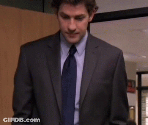 A Man In A Suit And Tie Is Looking At The Camera With A Serious Look On His Face . GIF
