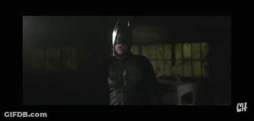A Man In A Suit And Tie Is Looking At The Camera With The Letters Ch Below Him GIF