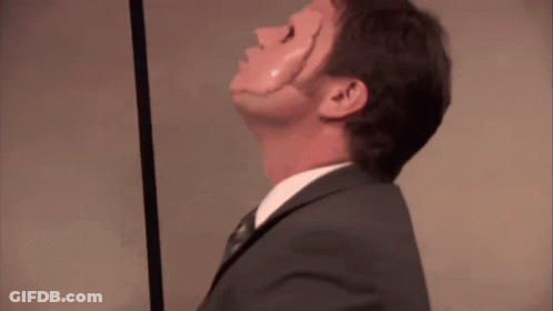 A Man In A Suit And Tie Is Looking Up GIF