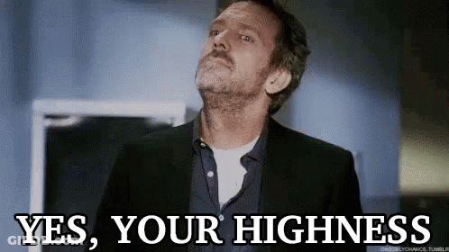 A Man In A Suit And Tie Is Looking Up And Saying Yes , Your Highness . GIF