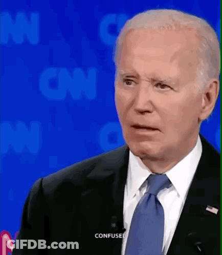 A Man In A Suit And Tie Is Making A Confused Face While Talking On Cnn GIF