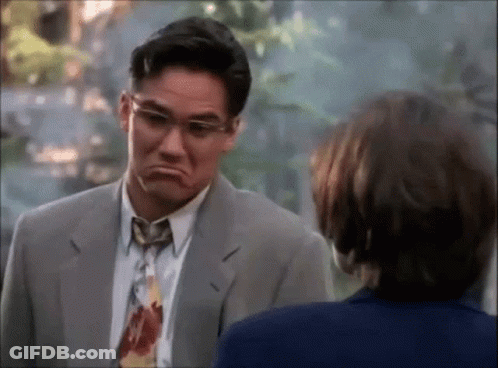 A Man In A Suit And Tie Is Making A Face GIF