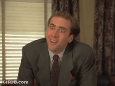 A Man In A Suit And Tie Is Making A Face GIF