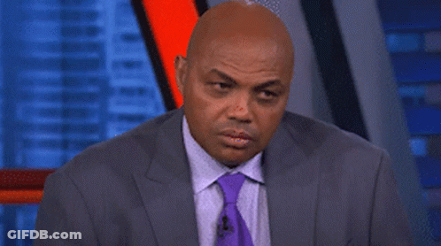 A Man In A Suit And Tie Is Making A Face GIF