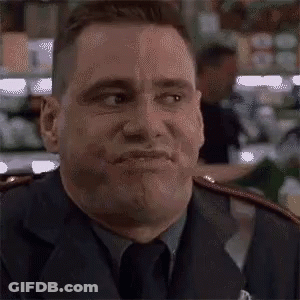 A Man In A Suit And Tie Is Making A Face . GIF