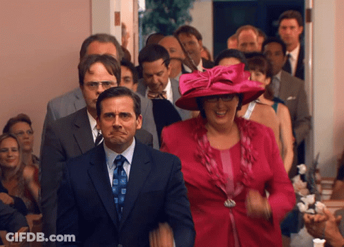 A Man In A Suit And Tie Is Making A Face GIF