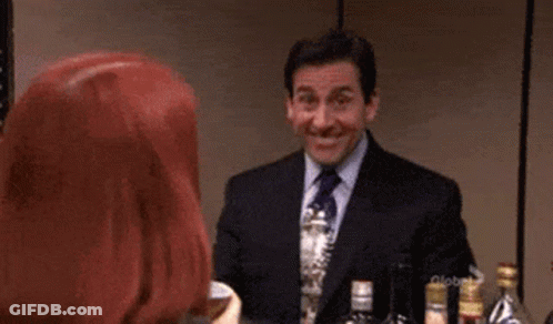 A Man In A Suit And Tie Is Making A Funny Face . GIF
