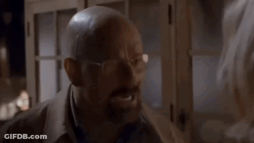 A Man In A Suit And Tie Is Making A Funny Face GIF