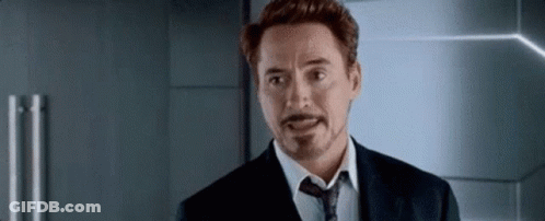 A Man In A Suit And Tie Is Making A Funny Face . GIF