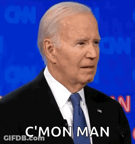 A Man In A Suit And Tie Is Making A Funny Face And Saying C 'Mon Man . GIF