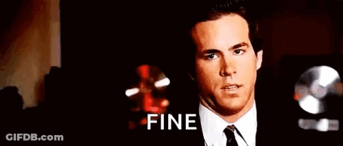 A Man In A Suit And Tie Is Making A Funny Face And Saying Fine . GIF