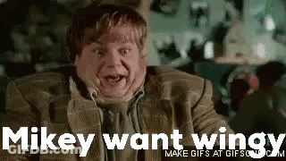 A Man In A Suit And Tie Is Making A Funny Face And Saying `` Mikey Want Wings '' . GIF