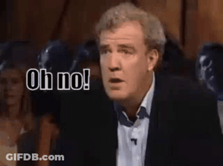 A Man In A Suit And Tie Is Making A Funny Face And Saying `` Oh No ! '' GIF